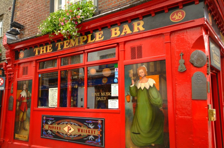 The Temple Bar Pubfront in close up with artwork of medieval characters, Brendan Vacations, Ireland